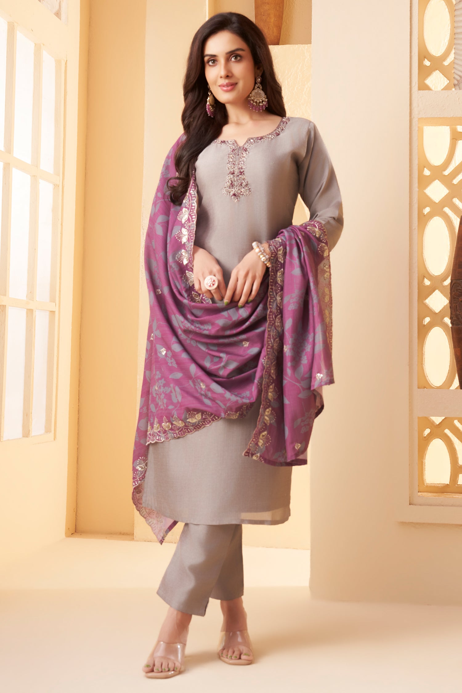 Model wearing traditional light grey art silk straight cut suit with printed dupatta