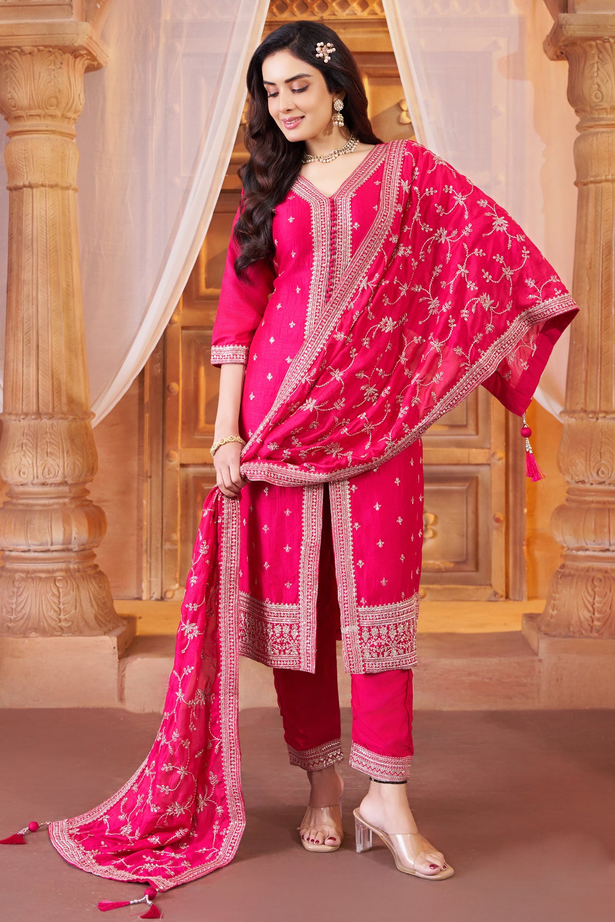 Model wearing festive rani pink art silk sequin embroidered straight cut suit
