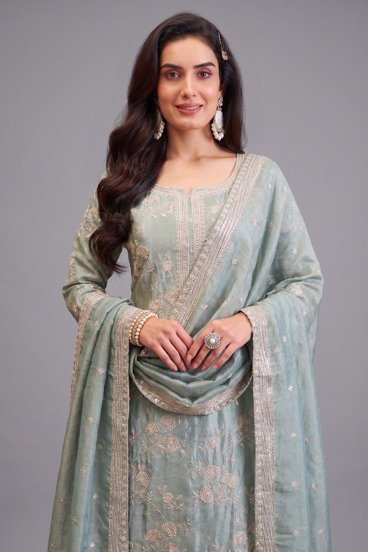 Close-up of intricate thread embroidery on Light Pista Green Tissue Suit fabric