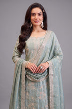 Close-up of intricate thread embroidery on Light Pista Green Tissue Suit fabric