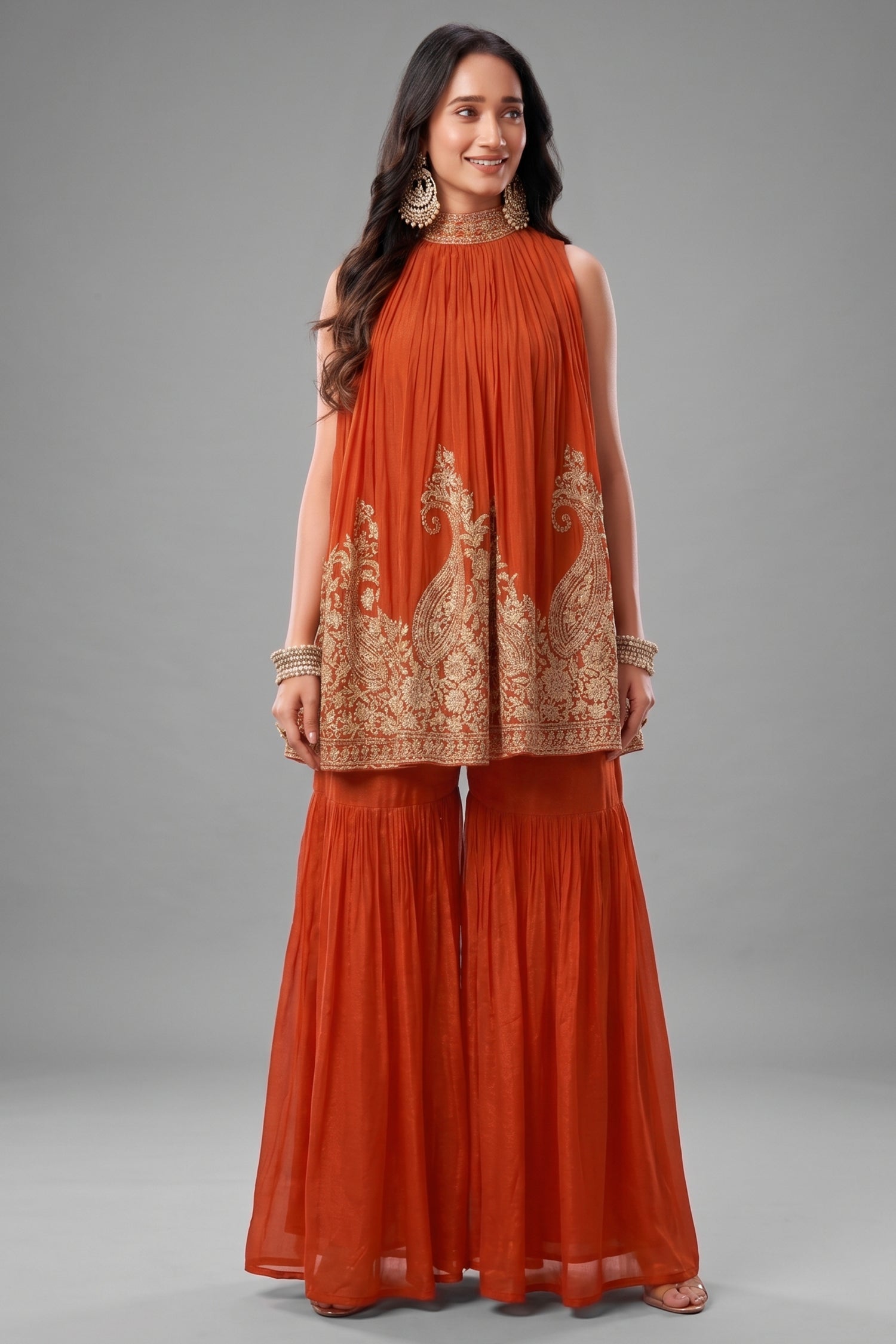 Orange georgette high neck sharara set with intricate sequin embroidery.