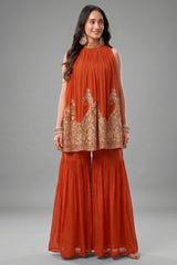 Orange georgette high neck sharara set with intricate sequin embroidery.