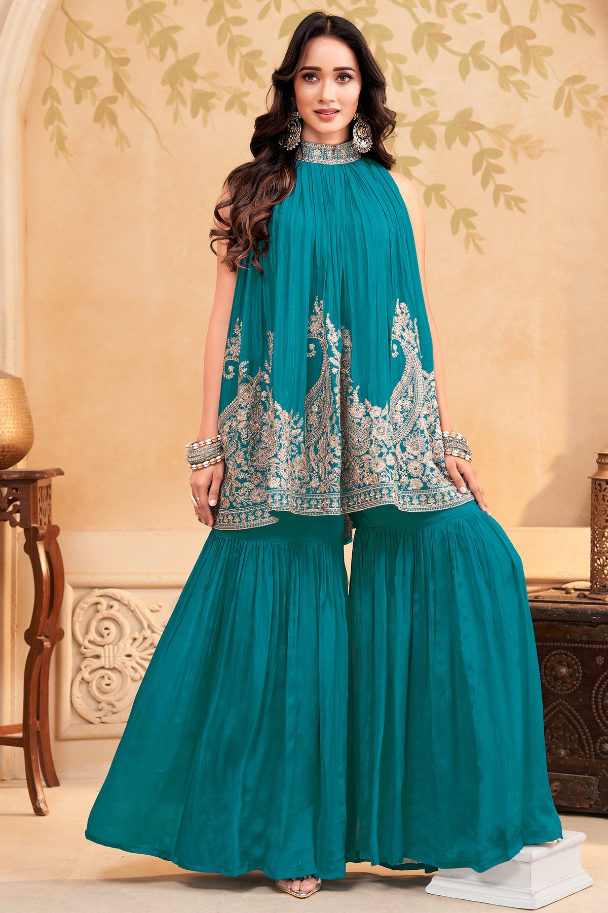 Turquoise blue georgette high neck sharara set with intricate sequin embroidery.