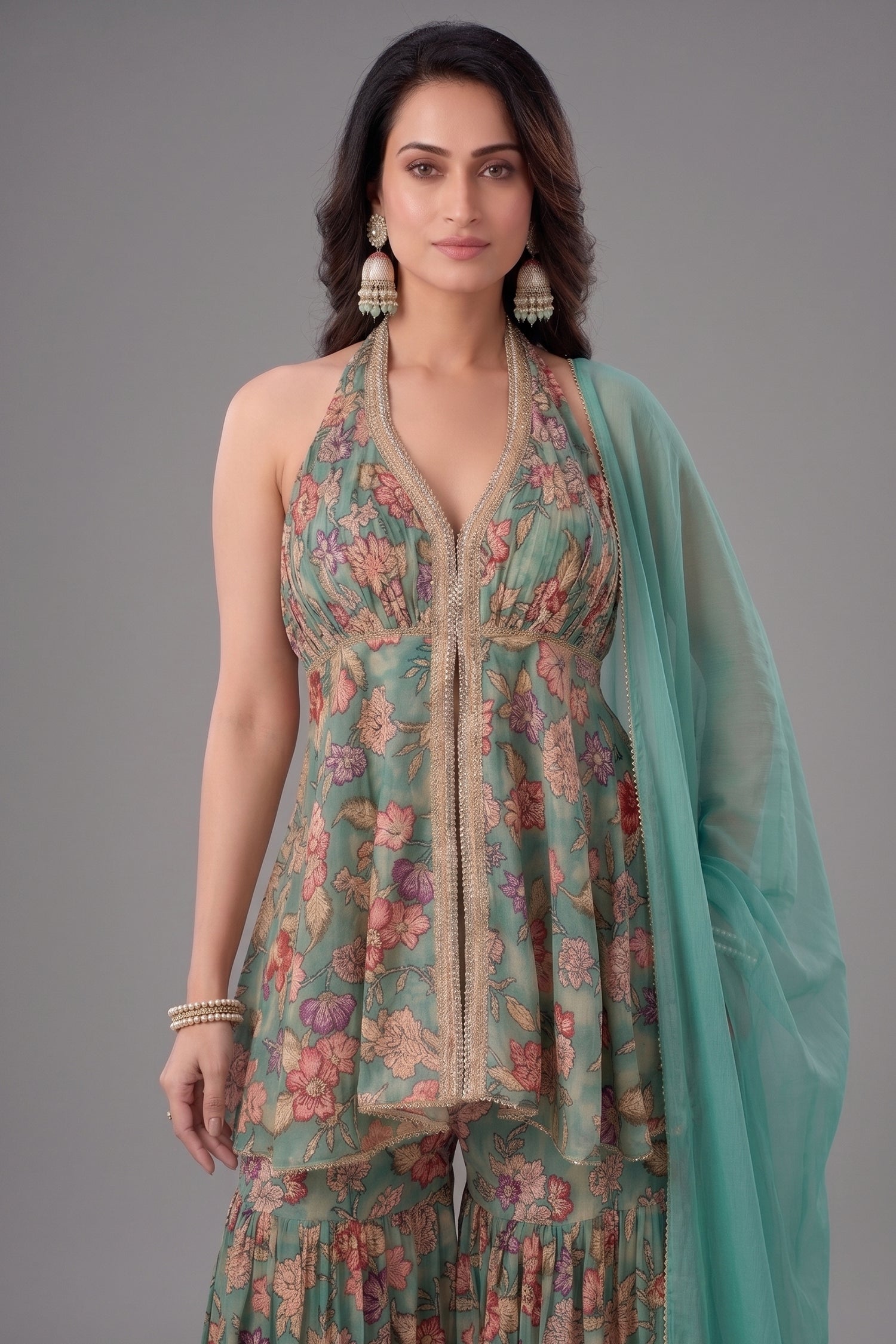 Detail of the floral printed tissue fabric and sequin embroidery on the sea green sharara.