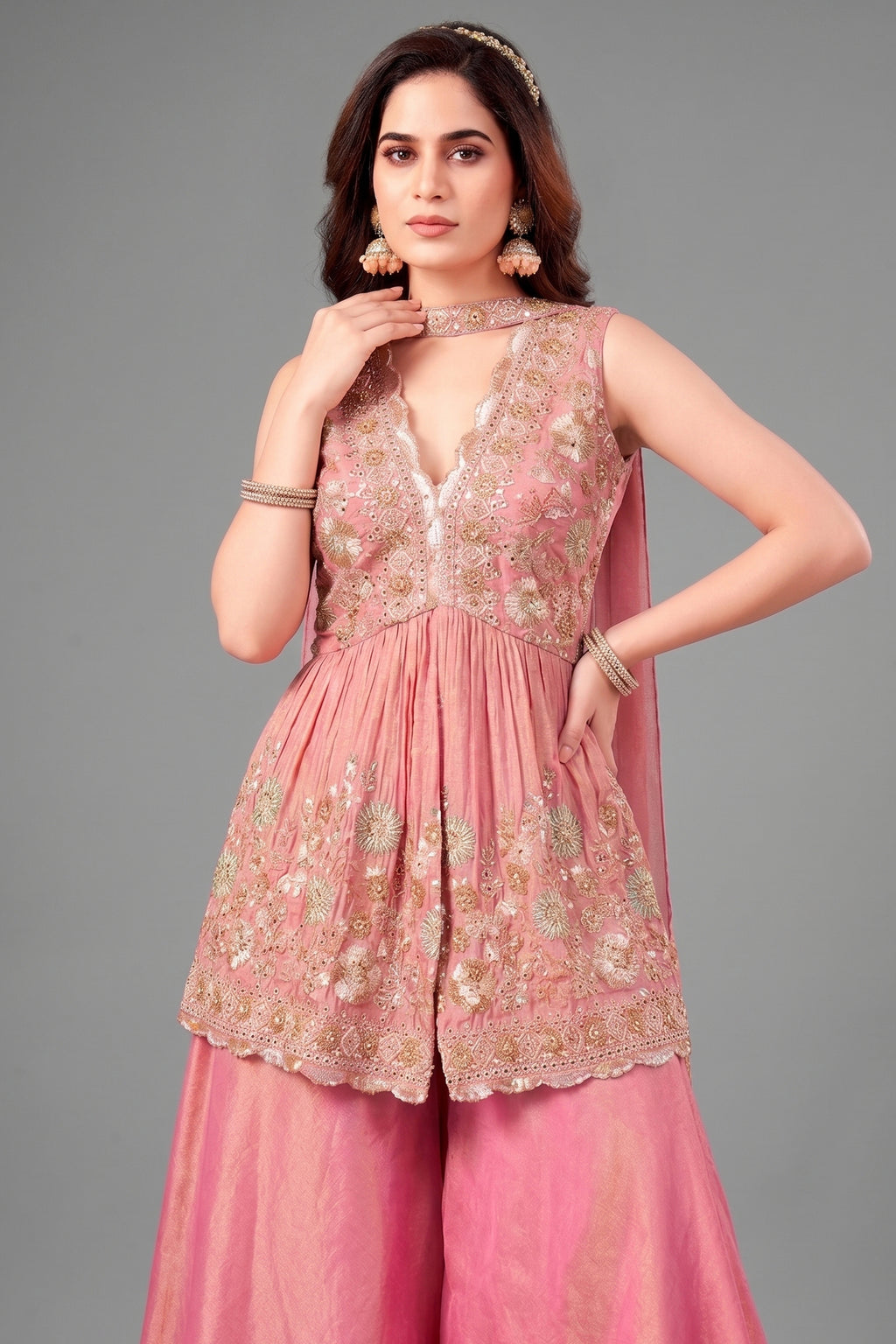 Detail shot of the intricate cutdana embroidery on the peplum bodice and silk fabric texture.