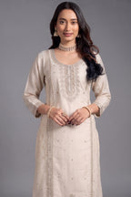 Opulent Creamy Ivory Art Silk Straight Cut Salwar Suit with Applique and Embroidery Work